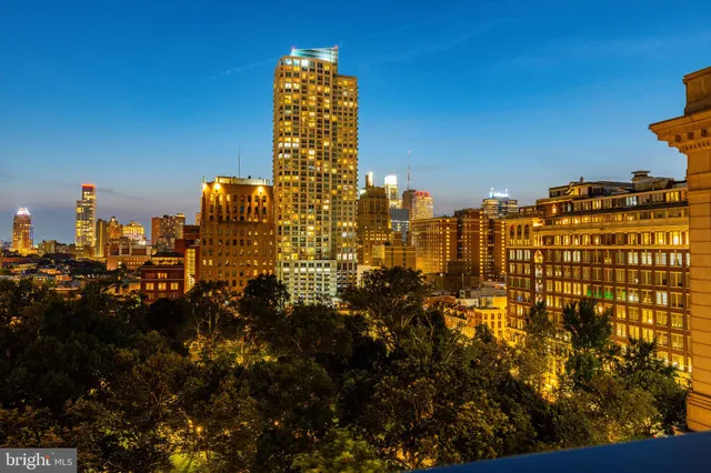 a living room with furniture and a glass door