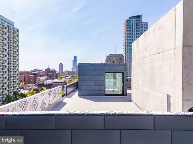 a view of roof deck with a barbeque and wooden stairs