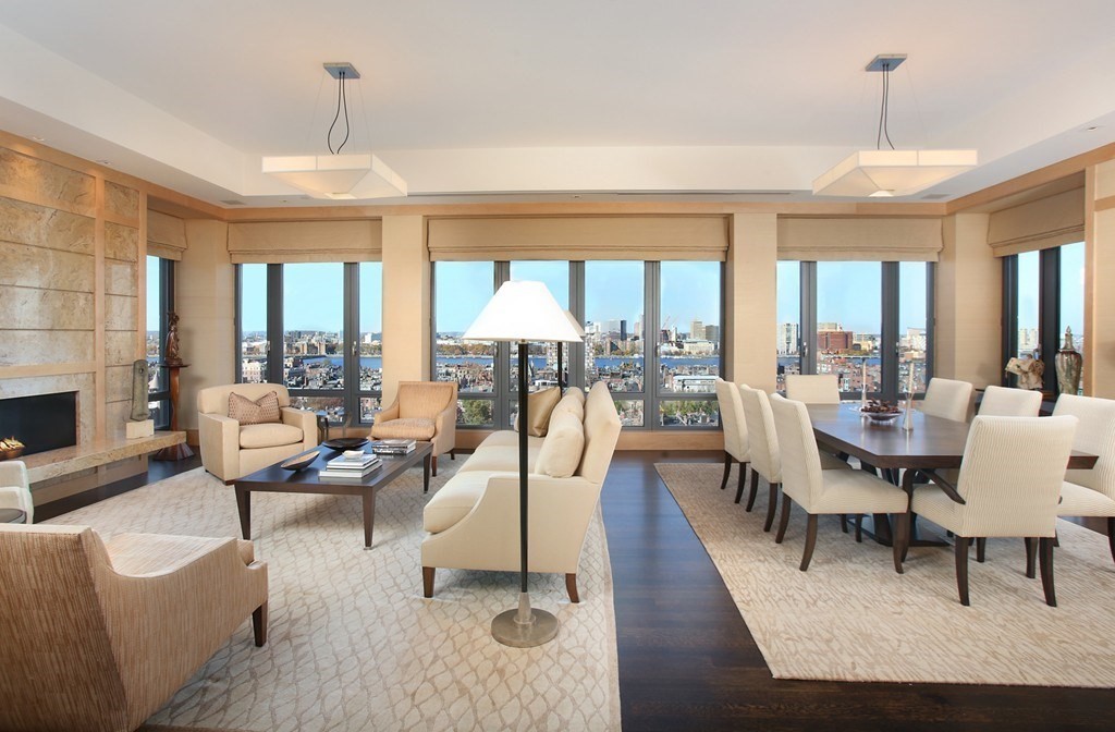 a living room with fireplace furniture and a large window