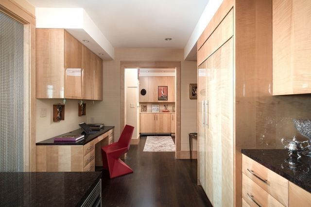 a kitchen with stainless steel appliances granite countertop a refrigerator a stove and a sink with wooden floor