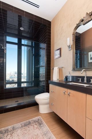 a bathroom with a sink a toilet a mirror and bathtub