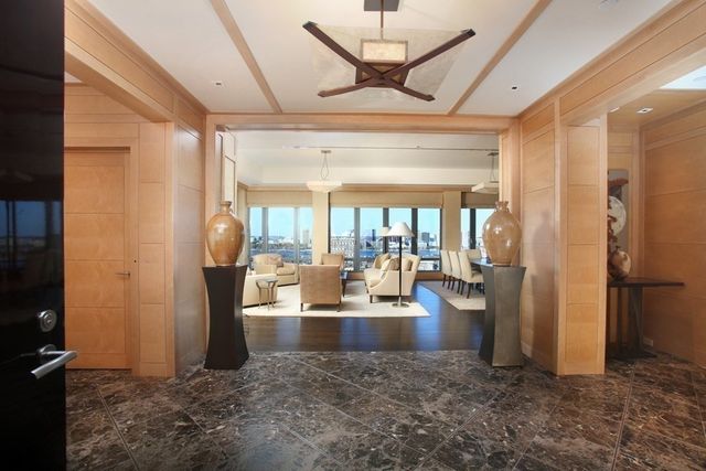 a living room with lots of furniture and a chandelier