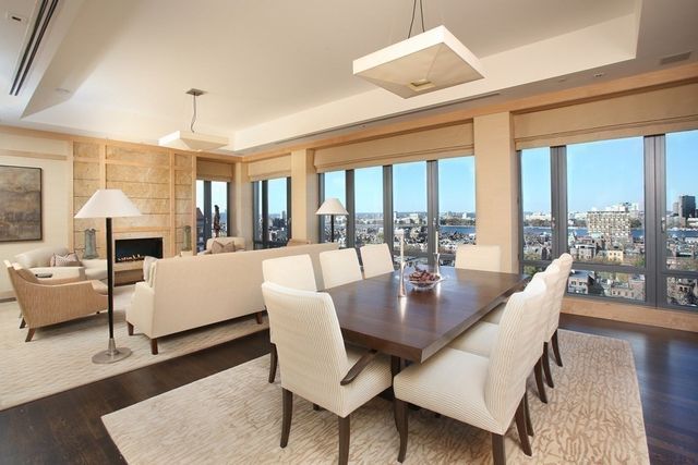 a dining room with furniture a chandelier and wooden floor