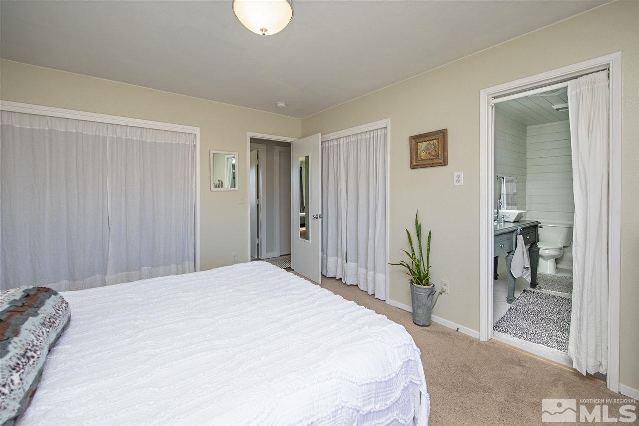 5805 Grass Valley Road Reno, NV 89510 - Photo 9 of 19 a spacious bedroom with a bed and a mirror