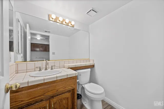 a bathroom with a sink a toilet and mirror