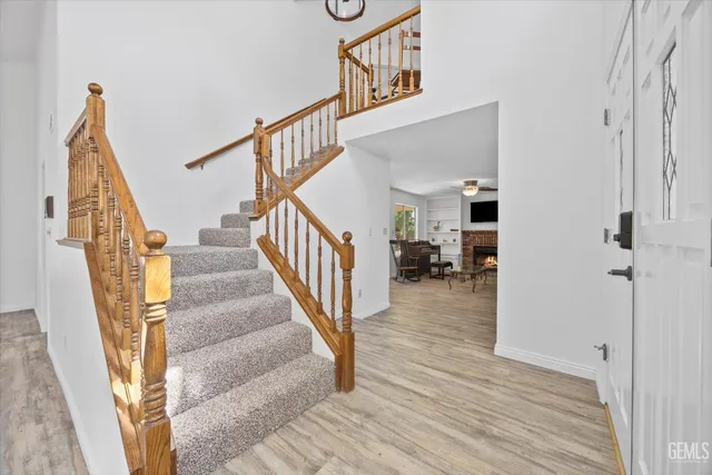 a view of a hallway with wooden floor and staircase