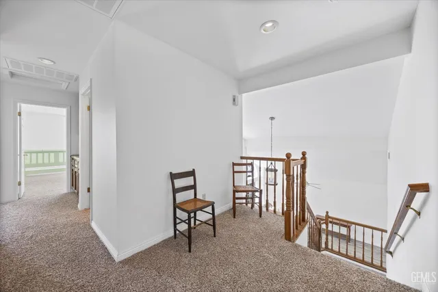 a view of a hallway with seating area