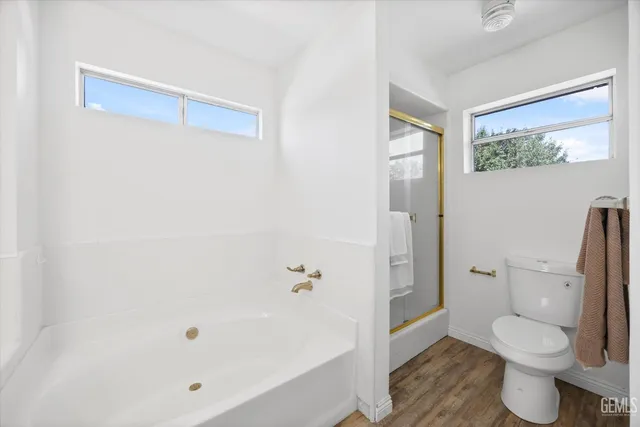 a bedroom with a bed and a potted plant