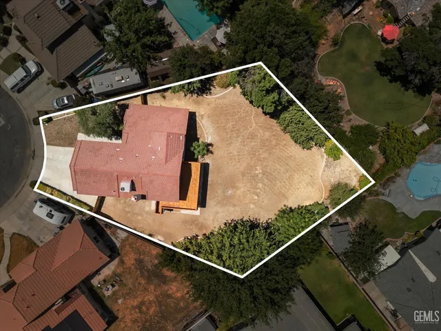 a front view of a house with a yard covered in snow