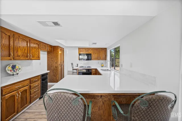 a kitchen with a stove a sink and a refrigerator