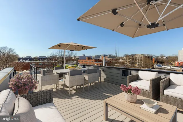 a view of a patio with tables and chairs