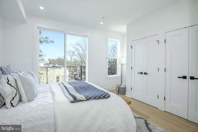 a spacious bedroom with a bed and a large window