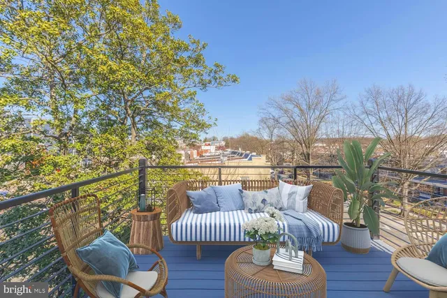 a balcony with furniture and wooden floor