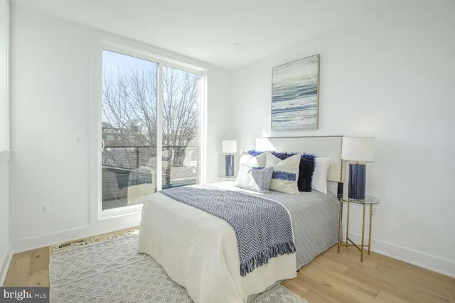 a bed sitting in a bedroom next to a window