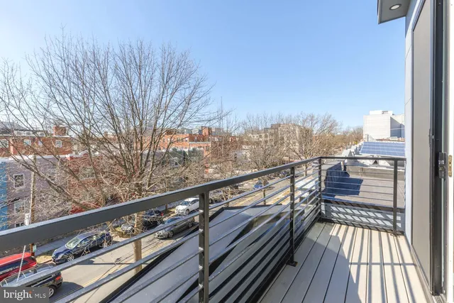 a view of balcony with wooden floor and fence