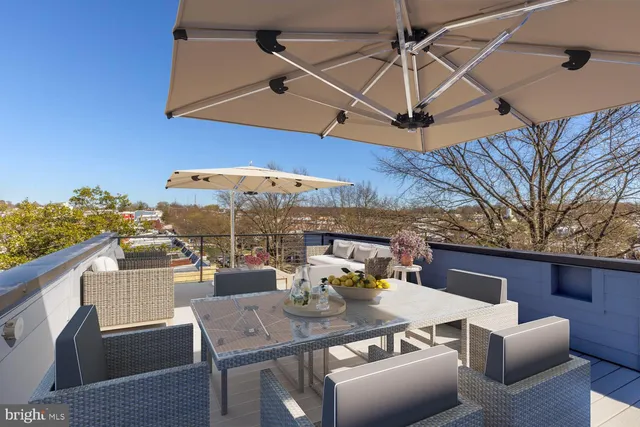 a view of a patio with a table and chairs