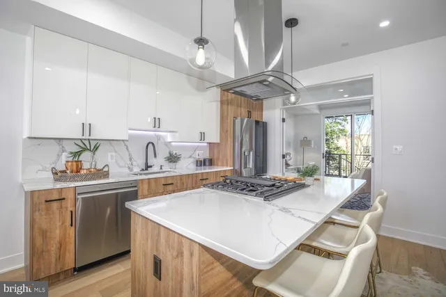 a kitchen with a table chairs and white cabinets