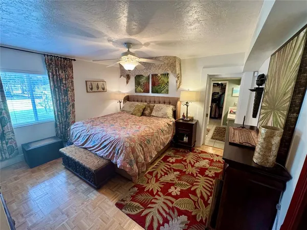 a living room with furniture a flat screen tv and a window