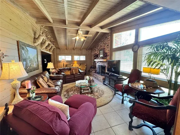 a room with fireplace furniture and a flat screen tv