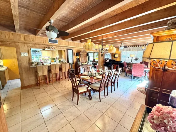 a view of a dining room with furniture and chandelier