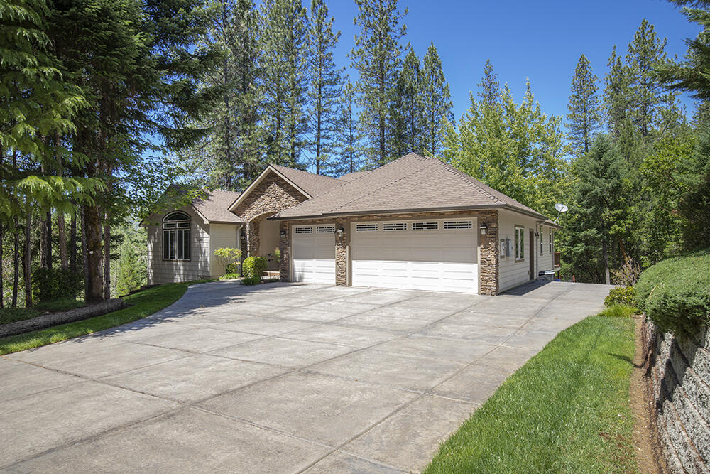 1280 Marcy Loop Road Grants Pass, OR 97527 - Photo 20 of 25 a front view of a house with a yard and trees
