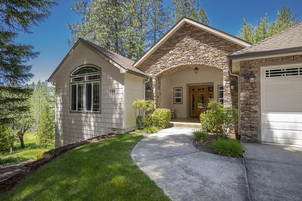 1280 Marcy Loop Road Grants Pass, OR 97527 - Photo 2 of 25 a front view of a house with a garden