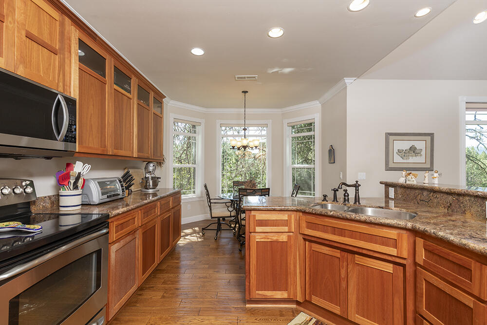 1280 Marcy Loop Road Grants Pass, OR 97527 - Photo 6 of 25 a kitchen with lots of counter top space and wooden floor