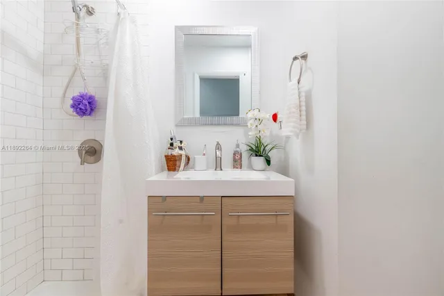 a bathroom with a sink vanity and mirror