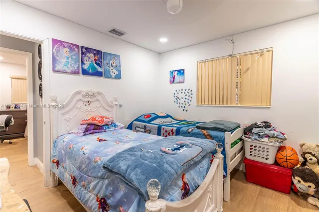 a bedroom with bed and a window