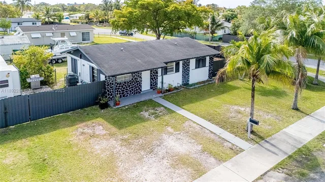 a aerial view of a house with swimming pool and a porch