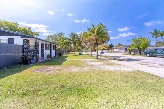 a swimming pool with outdoor seating and yard