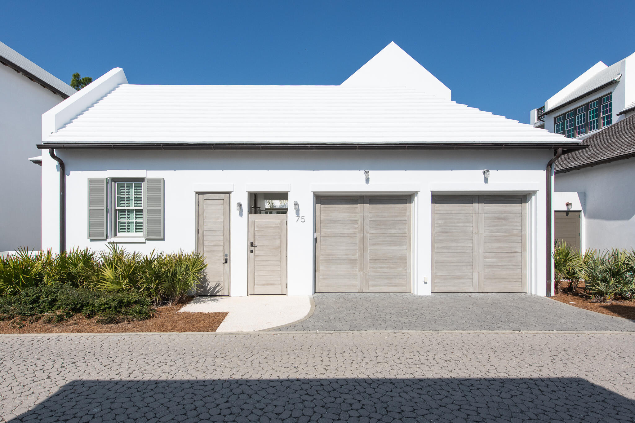 75 Featherbed Alley Inlet Beach, FL 32461 - Photo 39 of 49 a front view of a house with a yard and garage