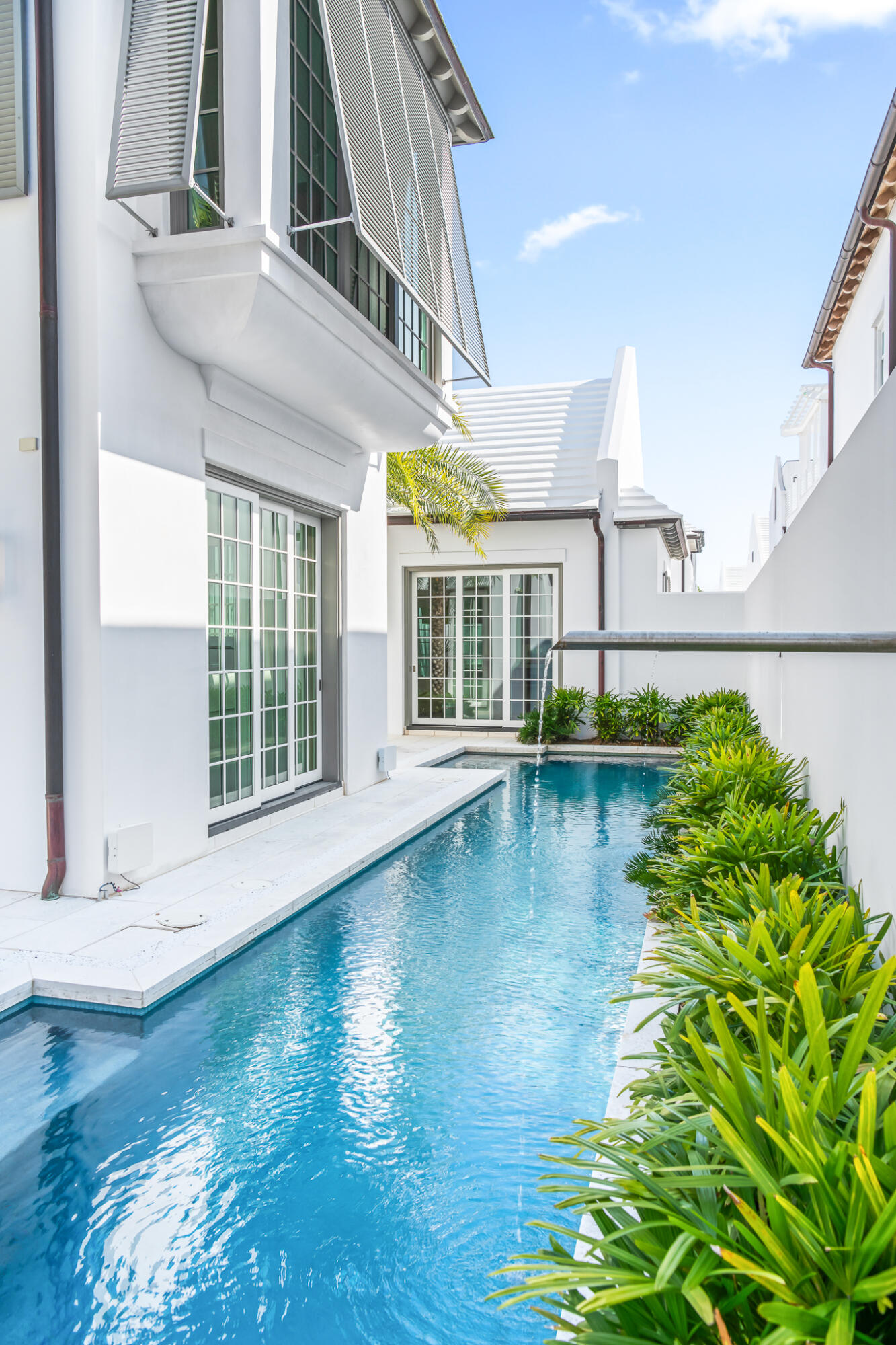 75 Featherbed Alley Inlet Beach, FL 32461 - Photo 5 of 49 a view of a white building next to a yard with potted plants