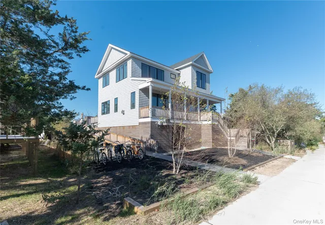 a view of a patio with couches and a table and chairs with wooden floor