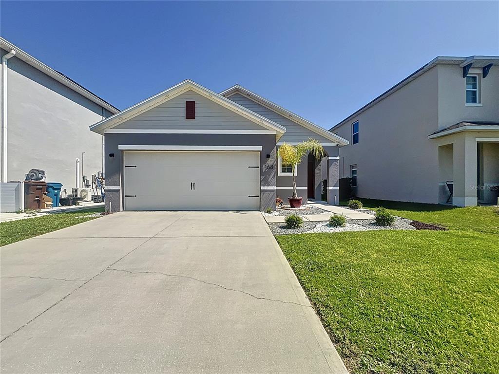 168 Eagleview Loop Davenport, FL 33837 - Photo 1 of 1 a front view of a house with a yard