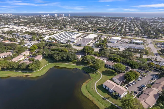 an aerial view of residential houses with outdoor space and trees