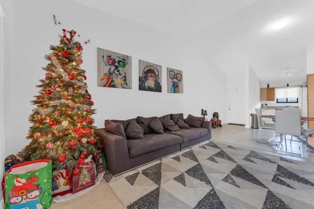 a living room with furniture and a christmas tree
