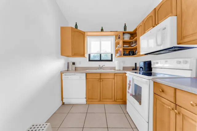 a kitchen with a sink cabinets and a window