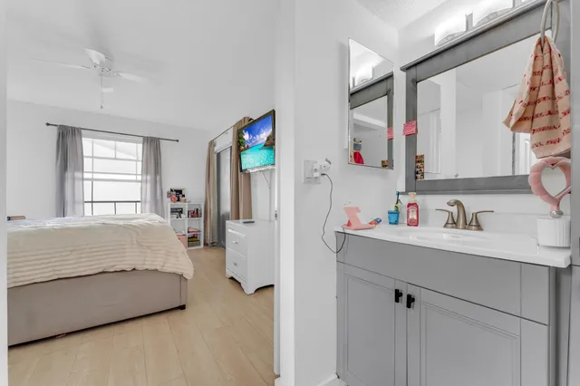 a bedroom with a bed dresser and a window