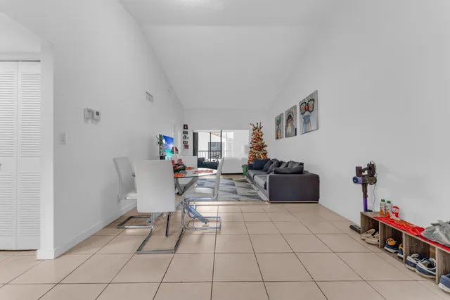 a living room with furniture and a dining table