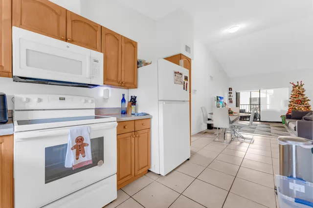 a kitchen with cabinets and a refrigerator