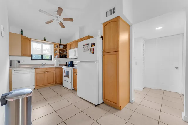 a kitchen with a refrigerator a sink and cabinets