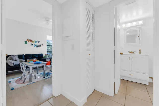a workspace with white cabinets and wooden floor