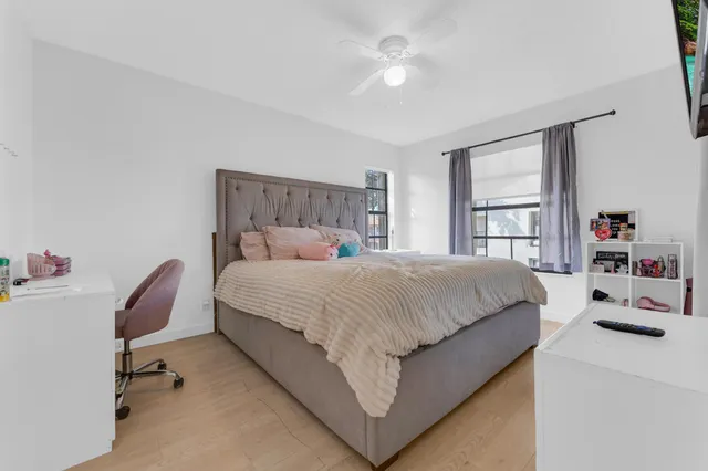 a bedroom with a bed and a chair in it