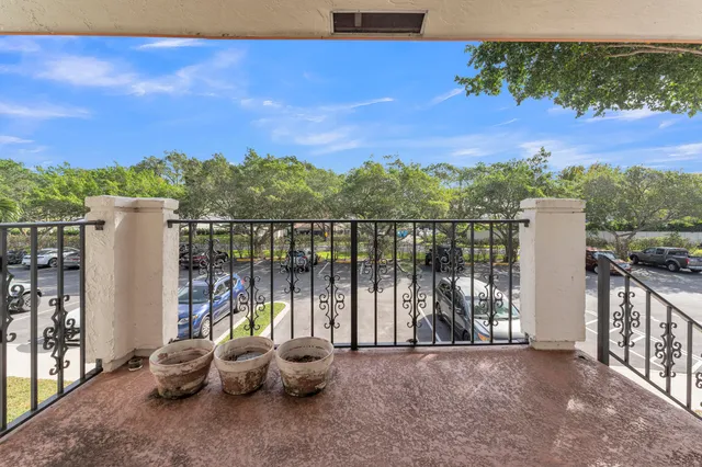 a view of a balcony with couches and city view