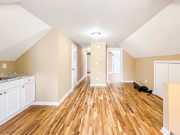 a view of a bedroom with wooden floor and bedroom