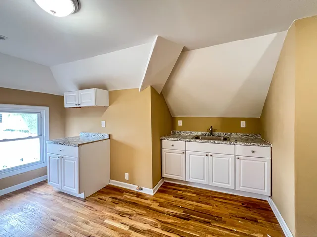 a kitchen with granite countertop a sink and a stove top oven