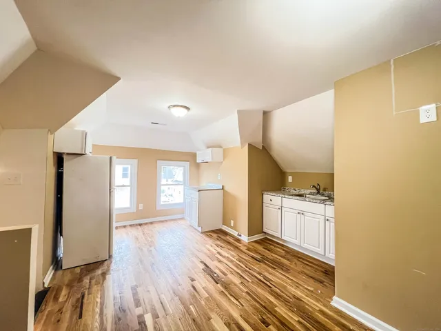 a view of a kitchen with a sink and cabinets