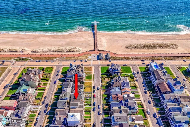 a front view of a house with a big yard and a garden