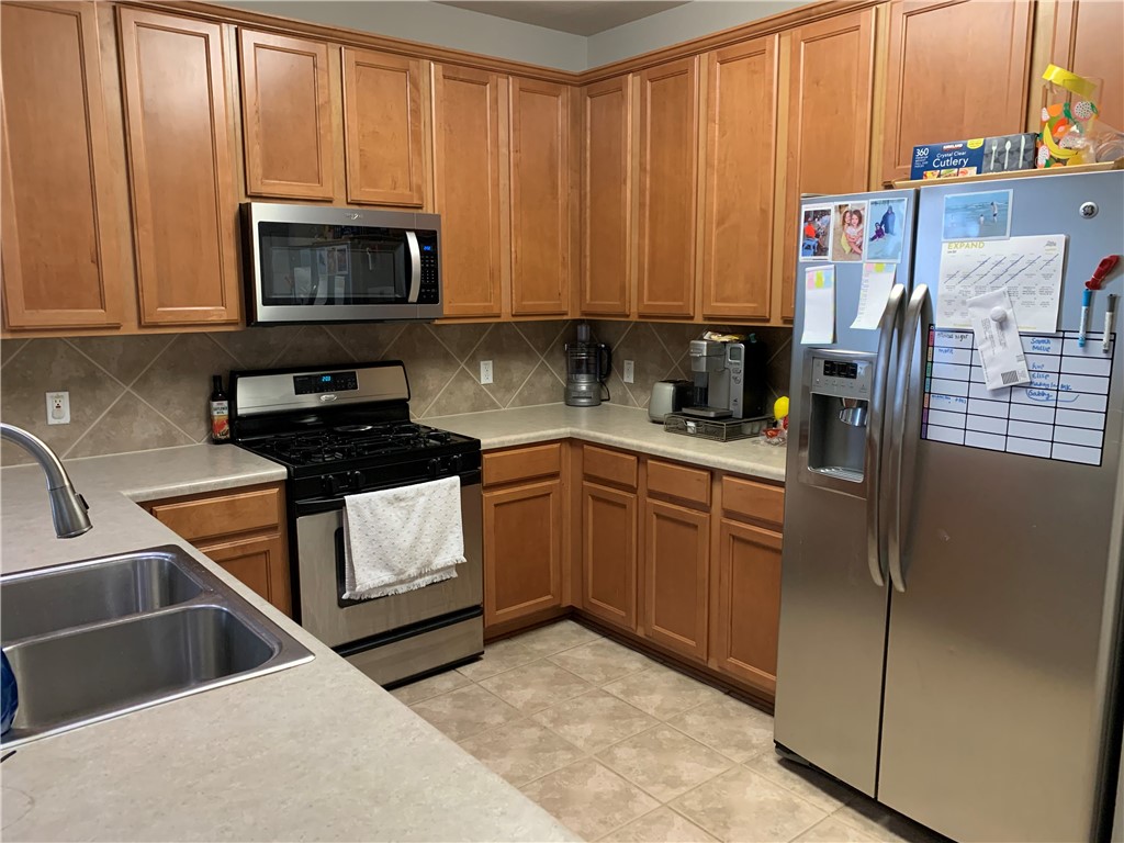 1900 Scofield Ridge Parkway, Unit 1202 Austin, TX 78727 - Photo 3 of 18 Spacious kitchen with stainless appliances and included refrigerator